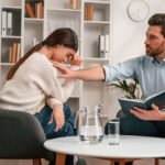 A supportive conversation in a cozy home setting, reflecting the therapeutic approach of The Guidance House.